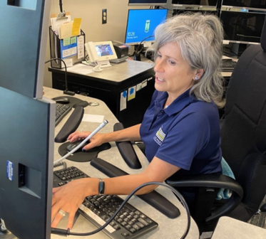 A photo of PCO Karla Melchior working in the Bel Air Police dispatch center.